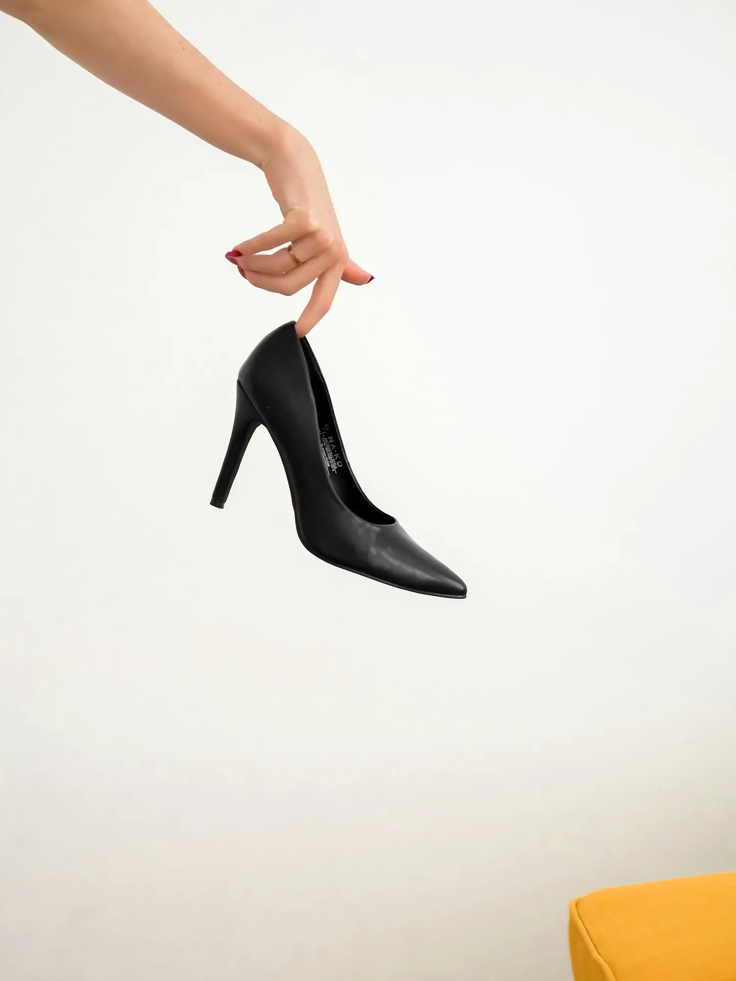 woman in black leather heeled shoes